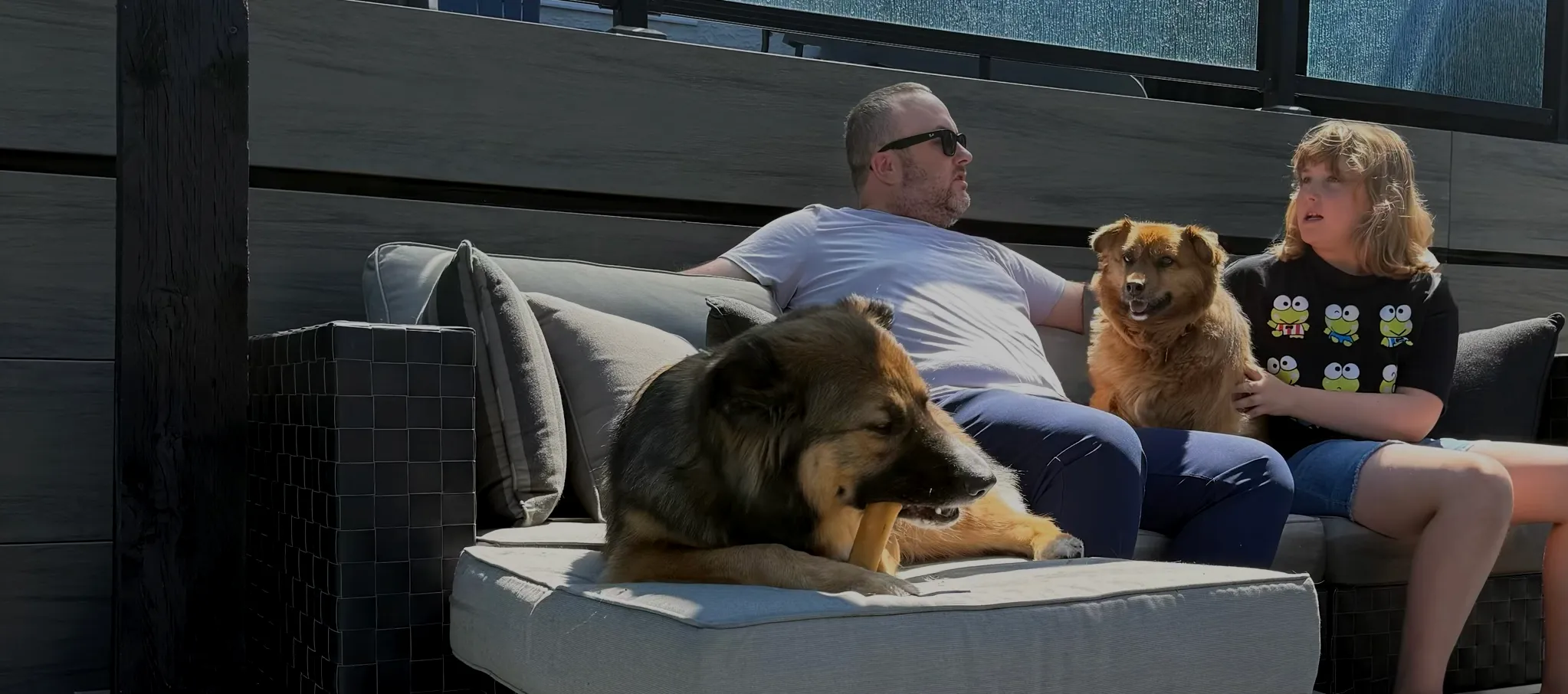 Jon Neumann at home with his daughter and two dogs.